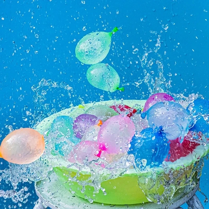 Colorful water balloons splashing out of a green basin against a blue background