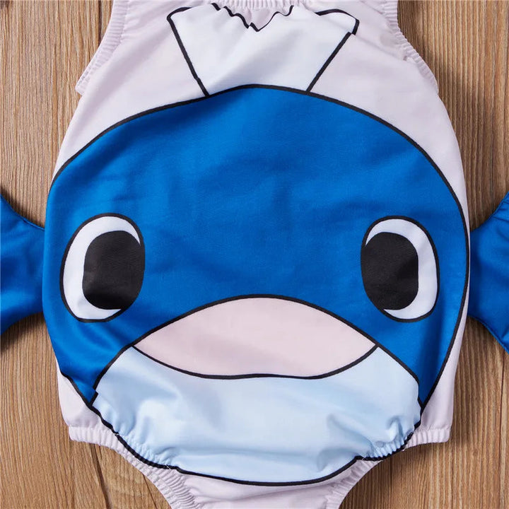 Close-up of the blue whale face and side fins on the pale one-piece swimsuit