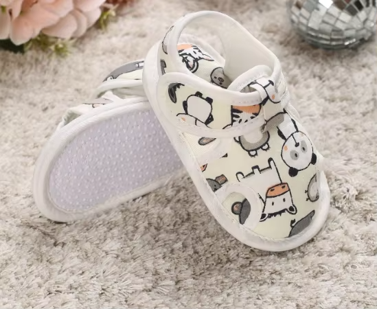 White animal-print baby sandals with one textured sole facing up