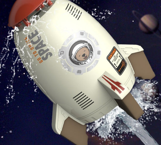 White rocket sprinkler with astronaut graphics spraying water around its red cap