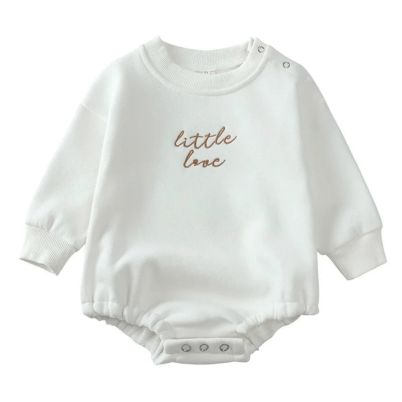 White cotton baby romper with brown chest embroidery and shoulder and crotch snaps