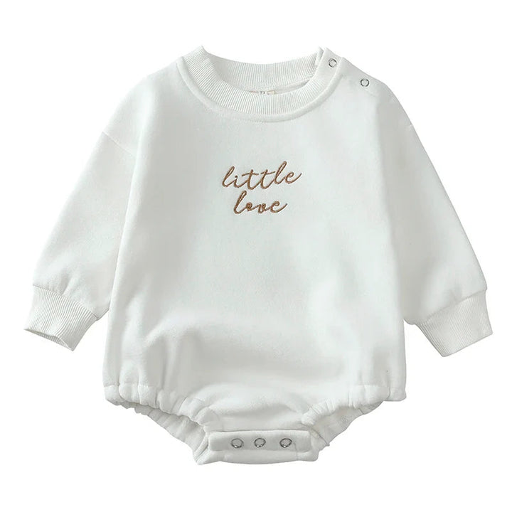 White cotton baby romper with brown chest embroidery and shoulder and crotch snaps