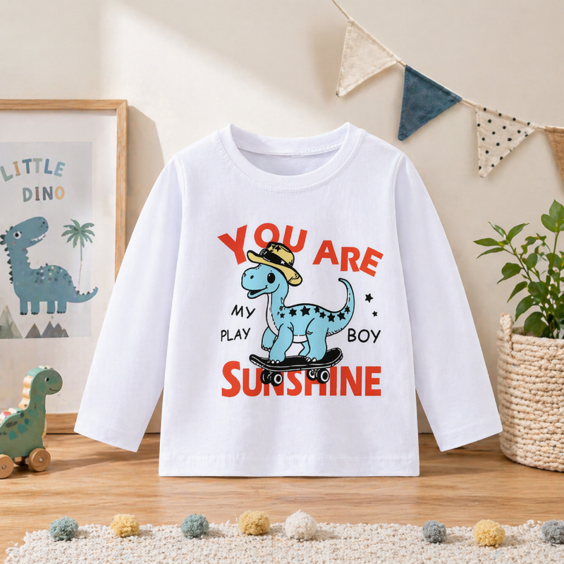 White sweatshirt with a blue cartoon dinosaur and red sunshine lettering
