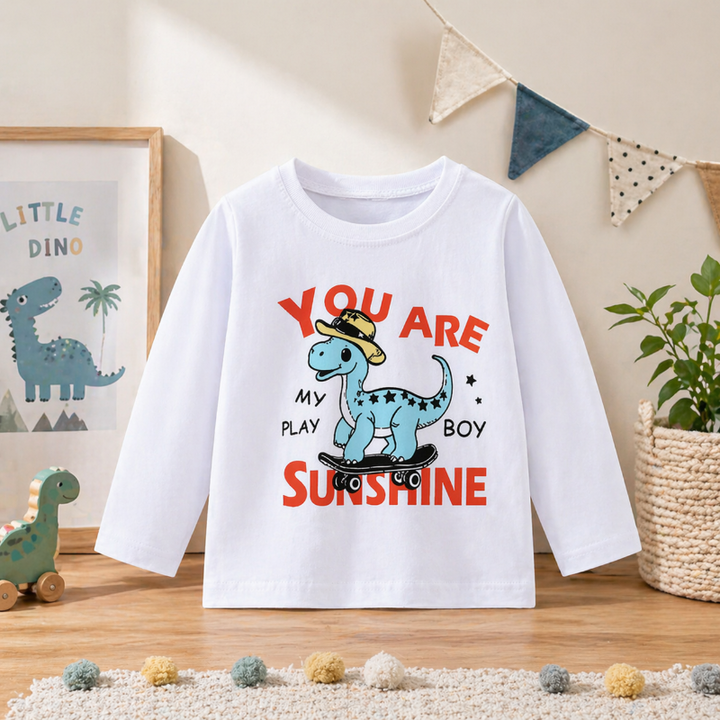 White sweatshirt with a blue cartoon dinosaur and red sunshine lettering