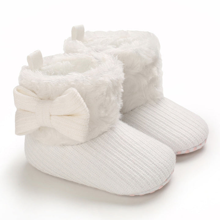 White baby boots with ribbed uppers, fluffy cuffs, and matching bows