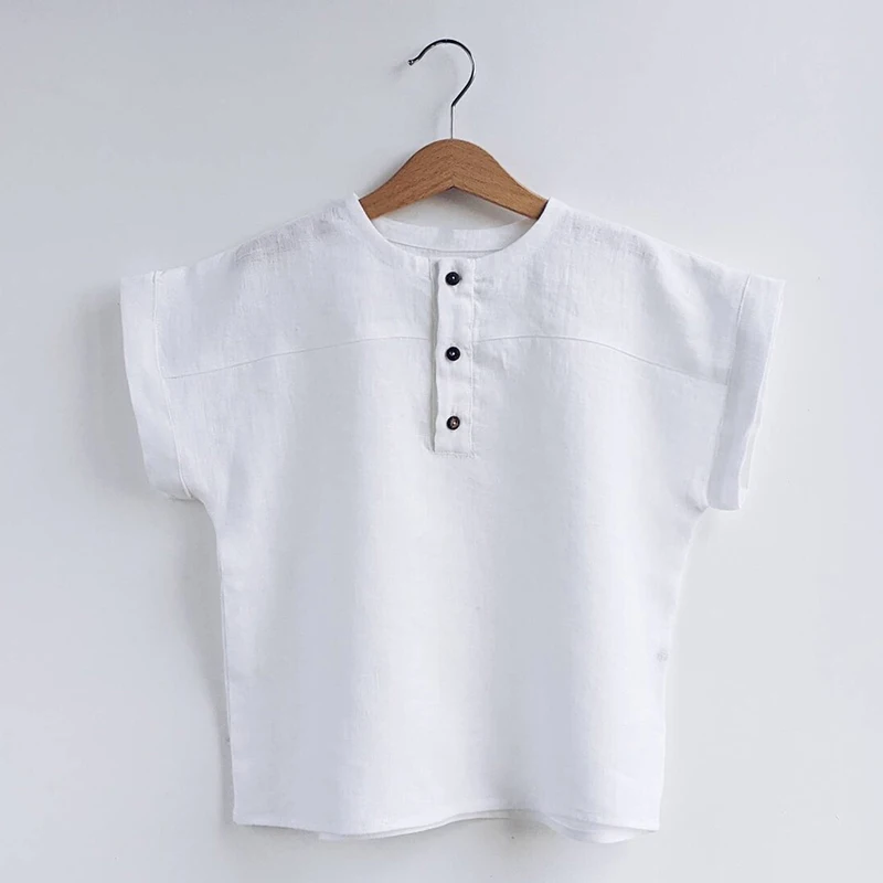 White short-sleeve shirt with contrasting front buttons on a hanger