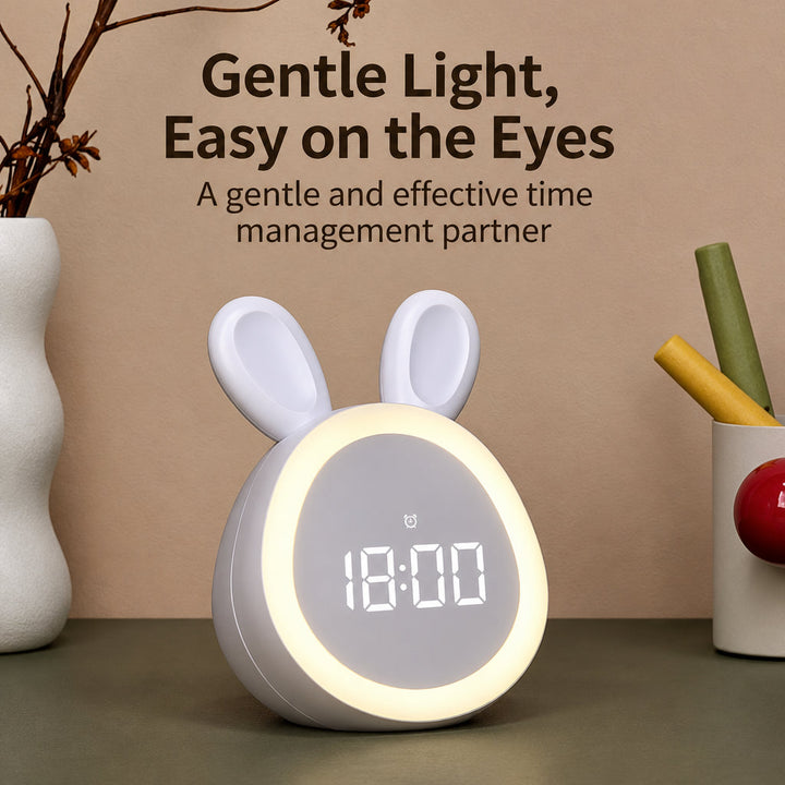 White bunny digital clock with a softly glowing light ring on a tabletop
