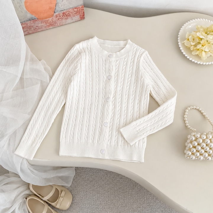 White cable-knit cardigan with a round neckline, front buttons, and long sleeves