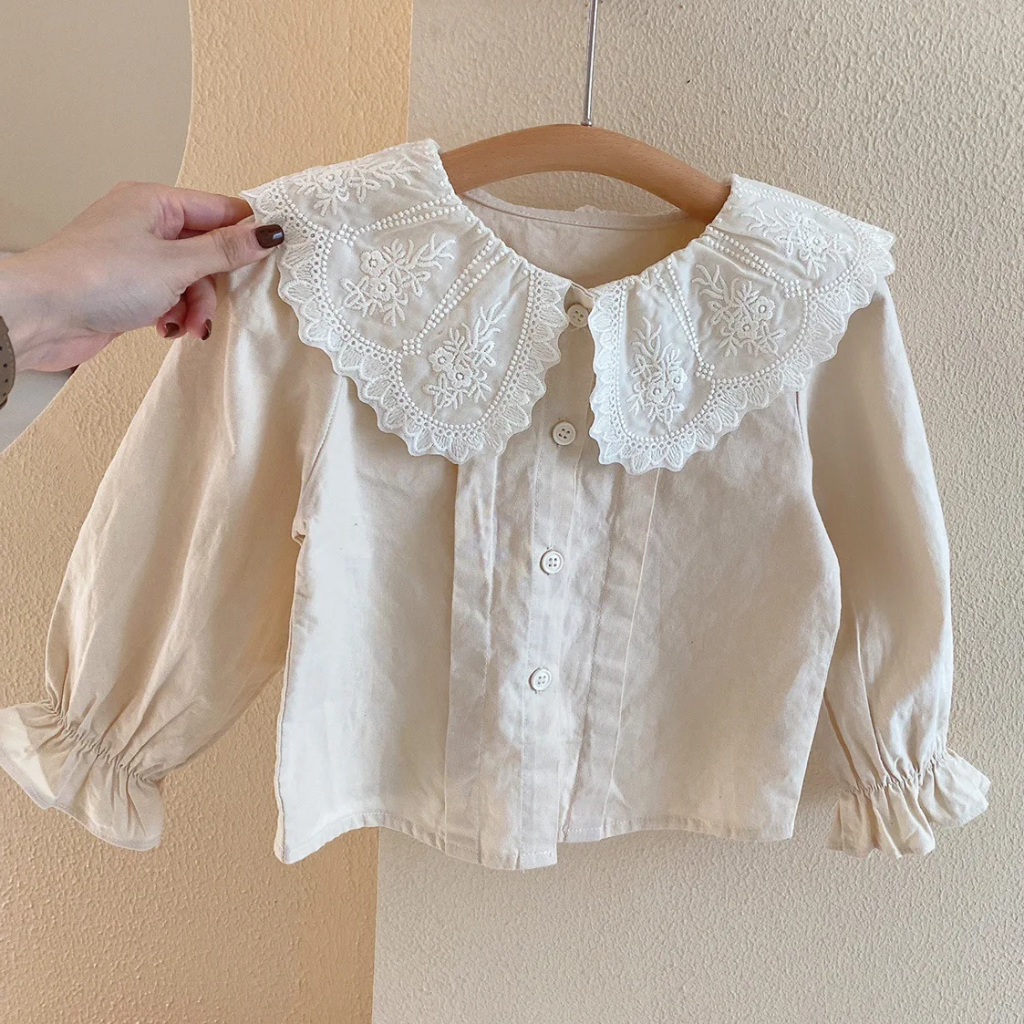 White button-front blouse with a wide embroidered collar and gathered long sleeves