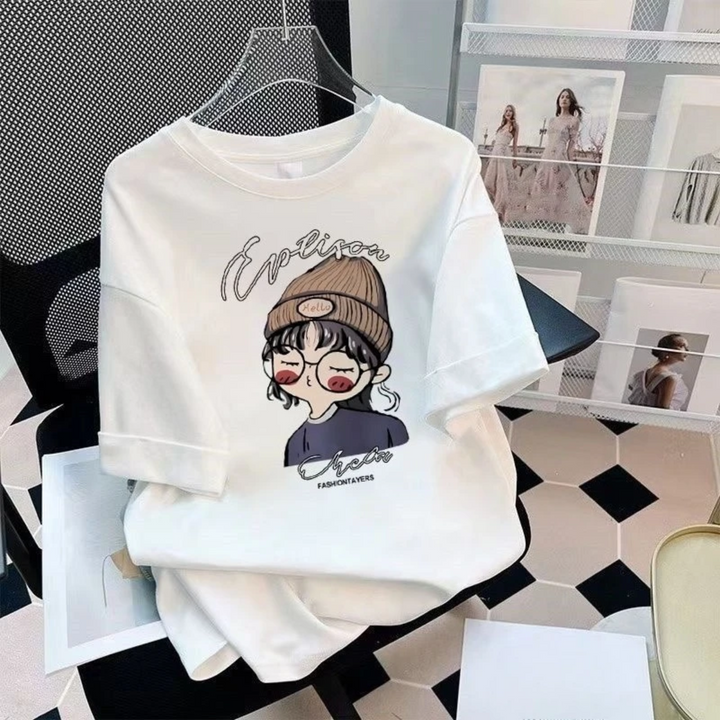 White cartoon-print T-shirt displayed on a hanger