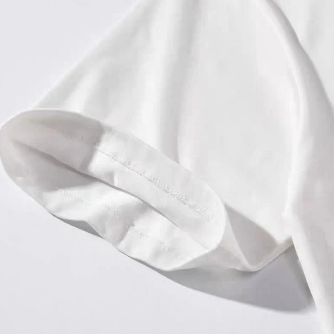 Close-up of the stitched sleeve hem on the white cotton-blend T-shirt