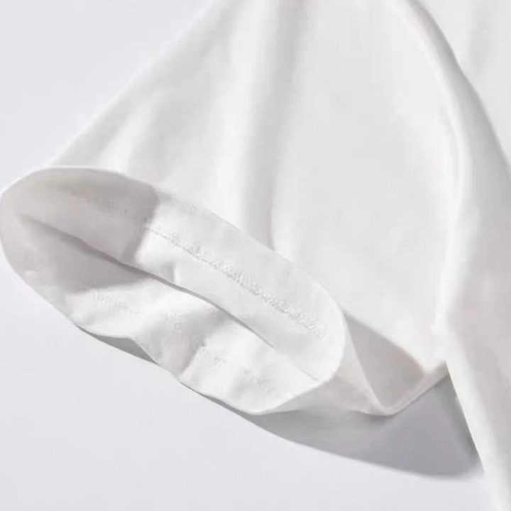 Close-up of the stitched sleeve hem on the white cotton-blend T-shirt