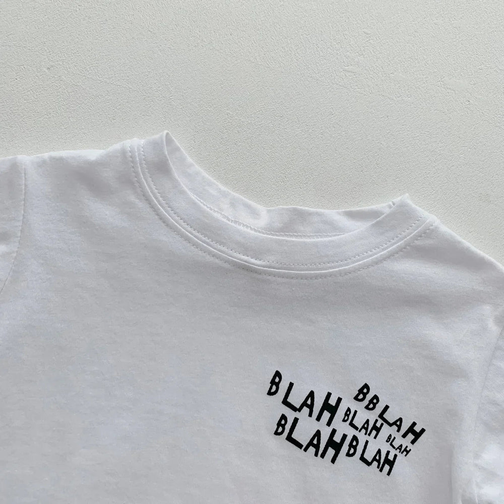 Close-up of the white crewneck T-shirt with a small black lettering graphic