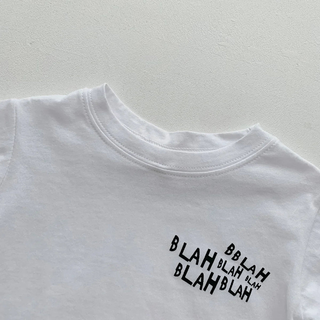 Close-up of the white crewneck T-shirt with a small black lettering graphic