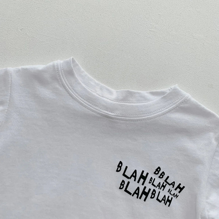 Close-up of the white crewneck T-shirt with a small black lettering graphic