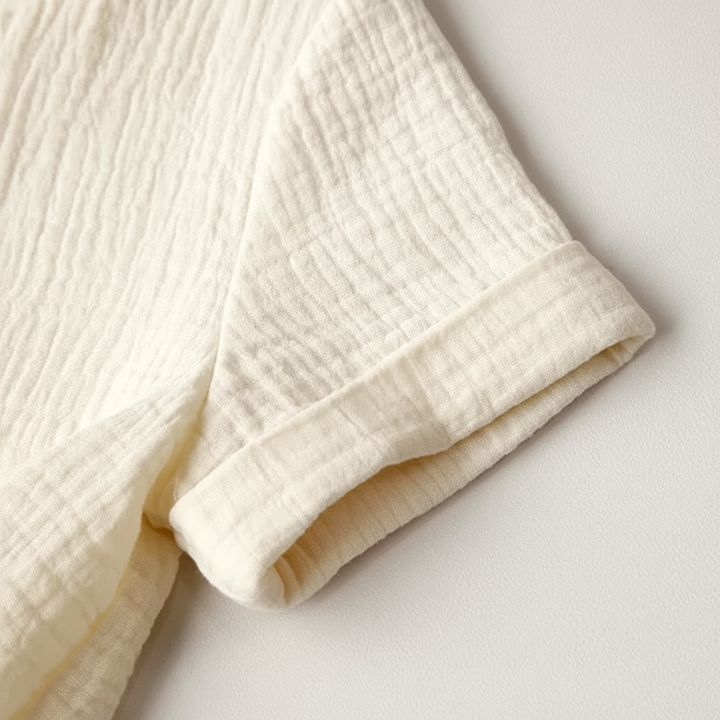 Short sleeve and stitched cuff detail on the White cotton dress.