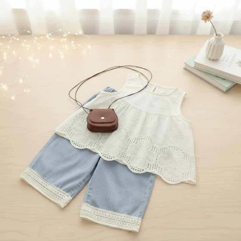 White embroidered sleeveless top paired with light blue lace-trimmed pants