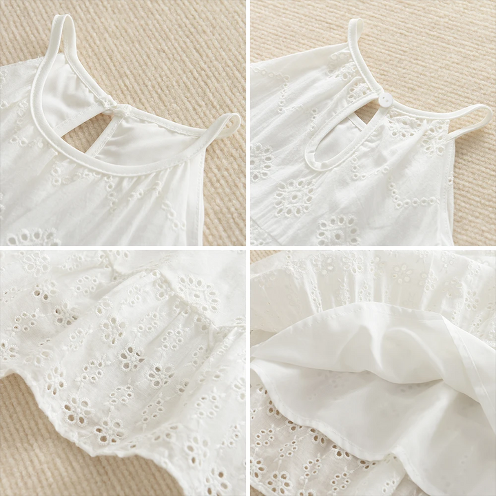 White dress details showing slim straps, neckline opening, embroidered hem and inner layer