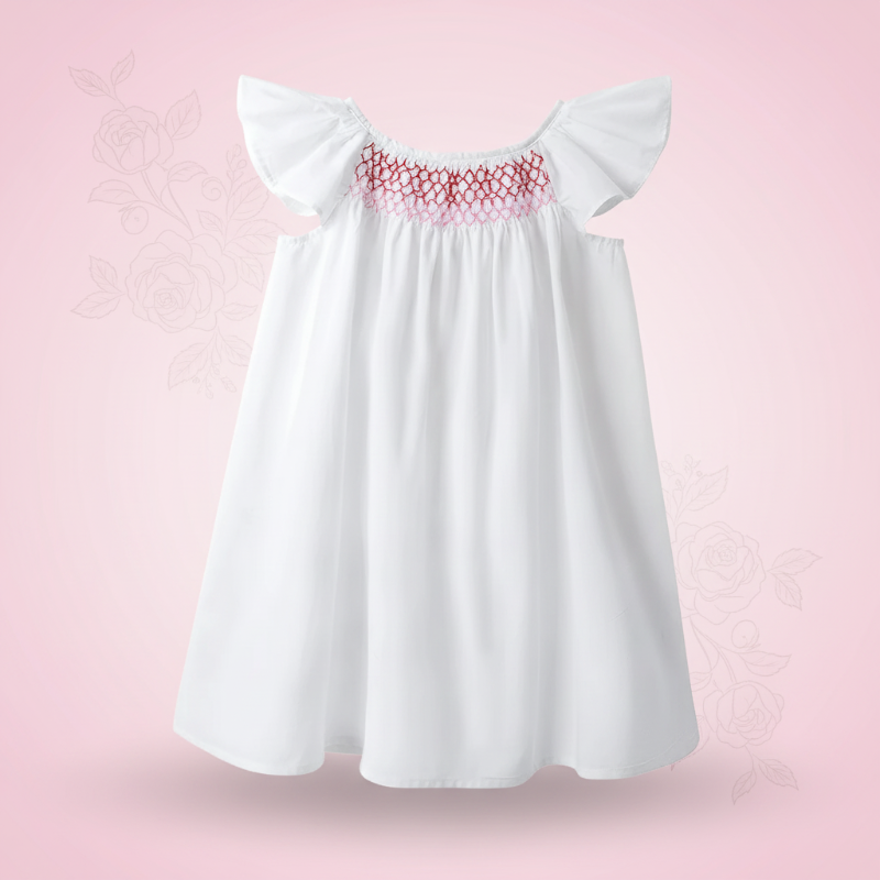 White A-line dress with flutter sleeves and contrasting pink smocking at the chest.