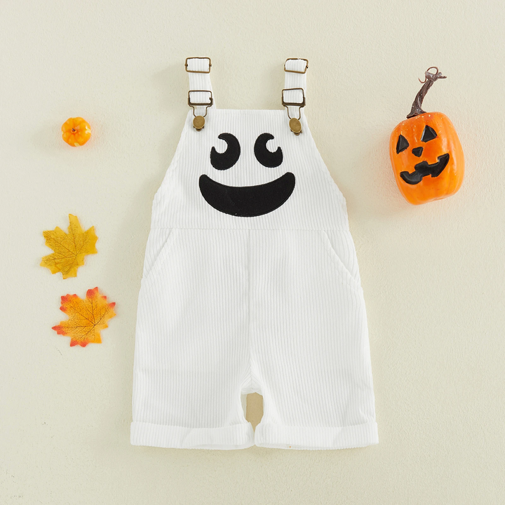 White ribbed ghost overalls with adjustable straps, shown beside fall leaves and a pumpkin decoration.