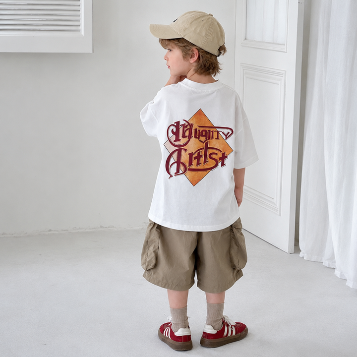 Back view of a child wearing the white graphic T-shirt with khaki shorts