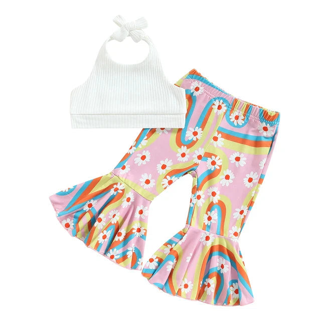 White halter top paired with pink rainbow-and-daisy print flared pants.
