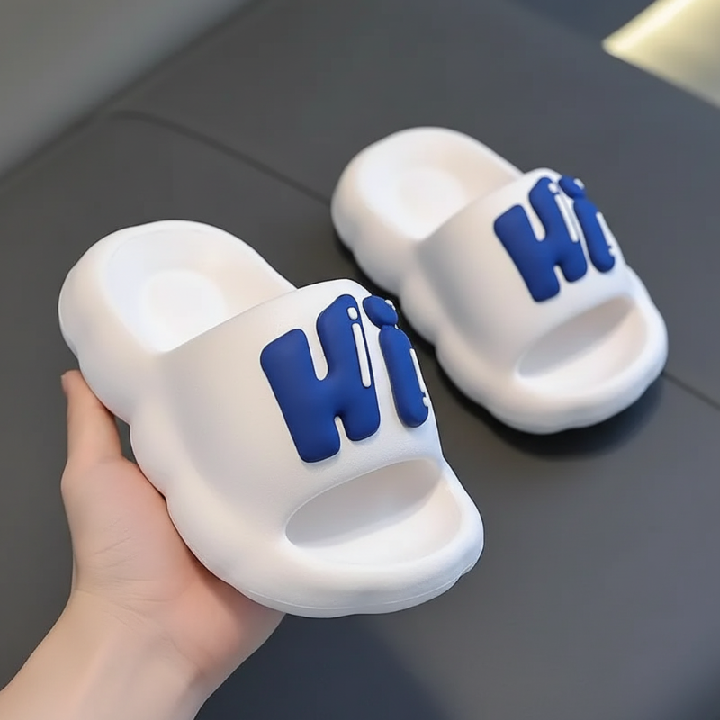 White slide slippers with raised blue Hi lettering.