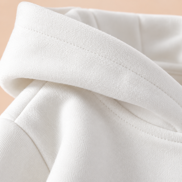 Close-up of the hood and shoulder stitching on a white kids&