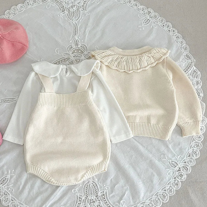 Back view of a white knit cardigan and strap bodysuit with a collared shirt underneath