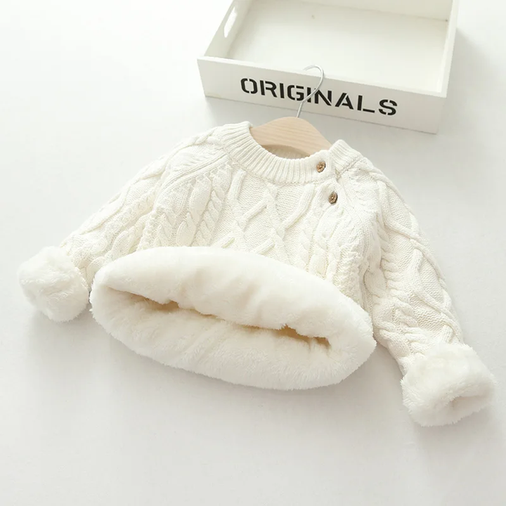White cable-knit sweater with plush lining visible inside the hem and cuffs.
