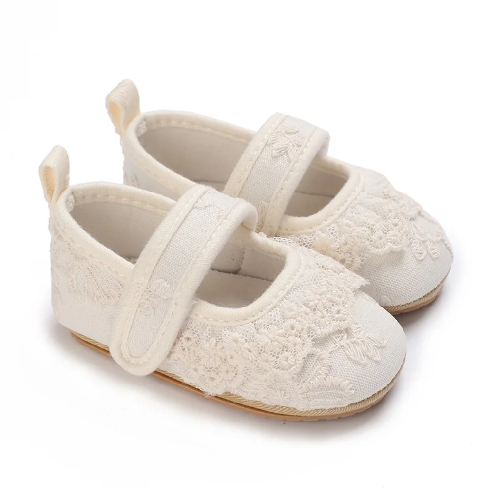 White lace baby shoes with rounded toes and hook-and-loop straps