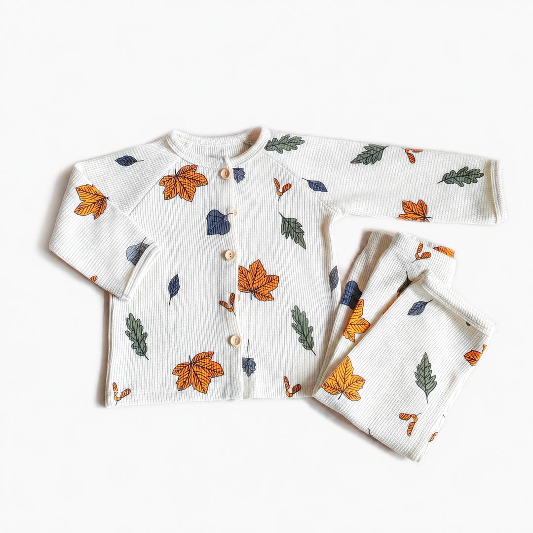 Leaf-print cotton pajama set with orange, green, and dark blue leaves