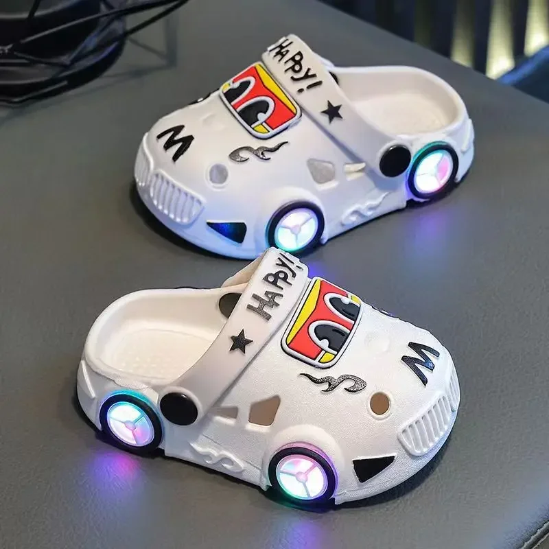 White car slippers with glowing wheel details and cartoon eyes.