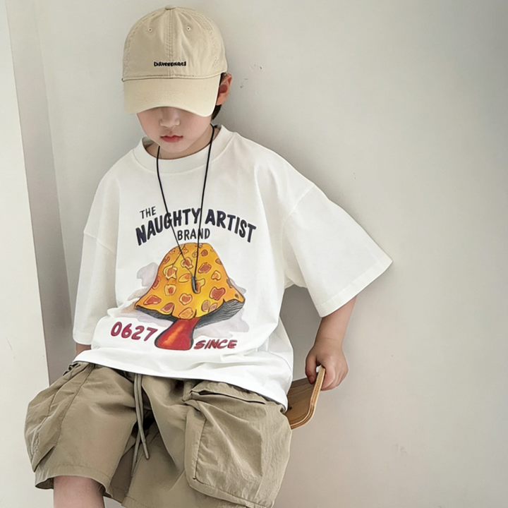 White mushroom T-shirt with a relaxed fit, worn with khaki shorts and a beige cap