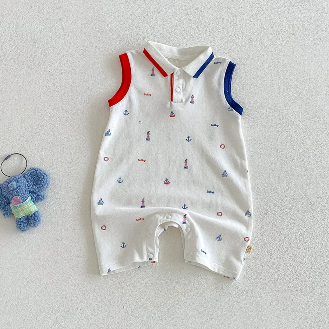 White sleeveless polo romper with nautical prints and contrasting red and blue trim