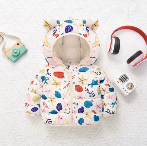 White puffer jacket with colorful ocean-themed prints and a bear-ear hood