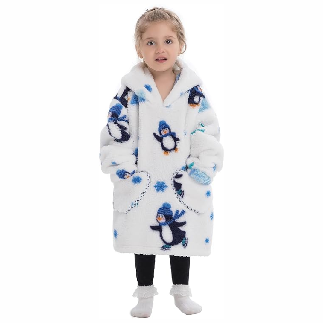 Child wearing a white penguin-print hooded blanket with two front pockets