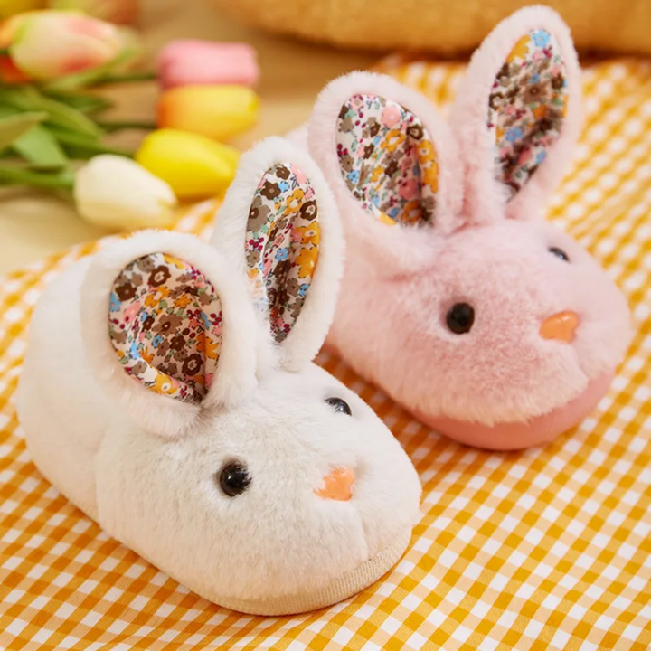 White and pink plush bunny slippers with colorful floral ear panels