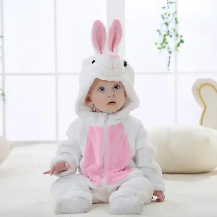 Baby wearing a white rabbit onesie with tall pink-lined ears and a pink belly