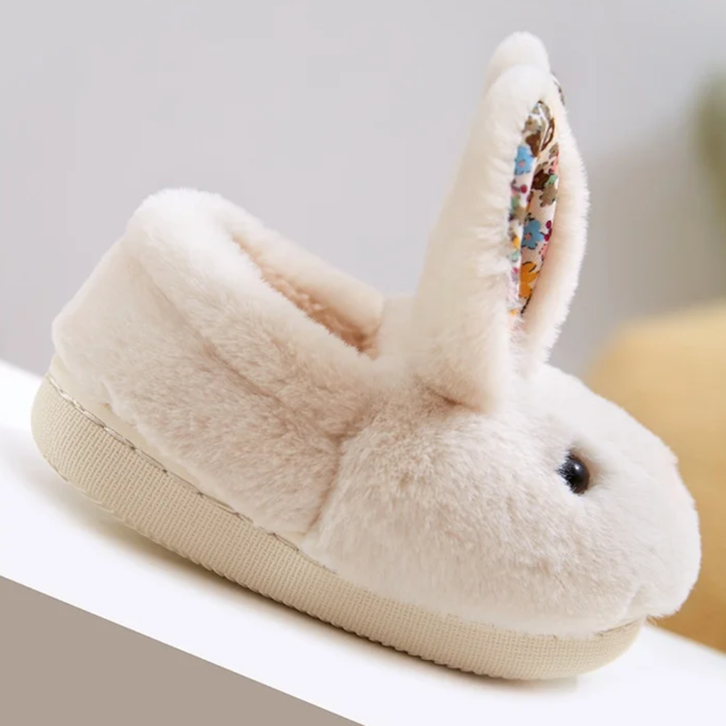 White plush rabbit slipper with a floral ear panel and a flat cream-colored sole