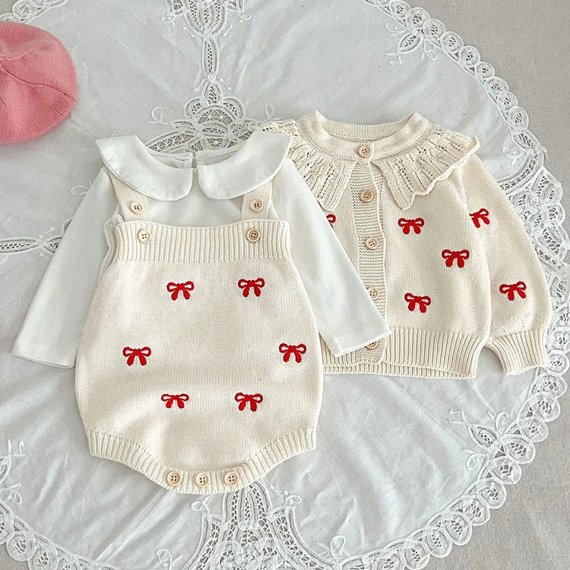 White knit cardigan and bodysuit with red bow motifs styled with a white collared shirt
