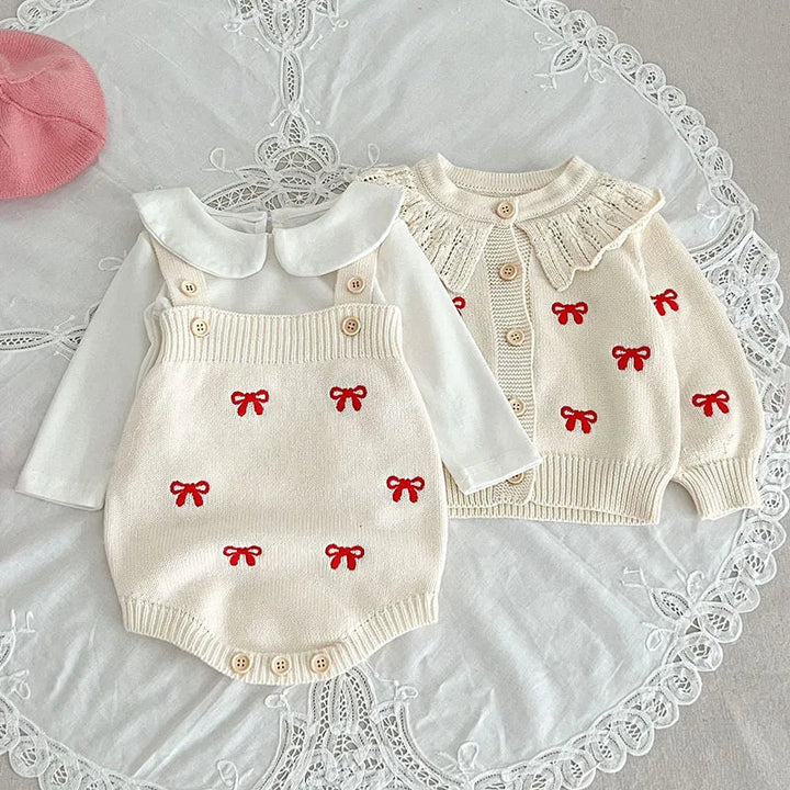 White knit cardigan and bodysuit with red bow motifs styled with a white collared shirt