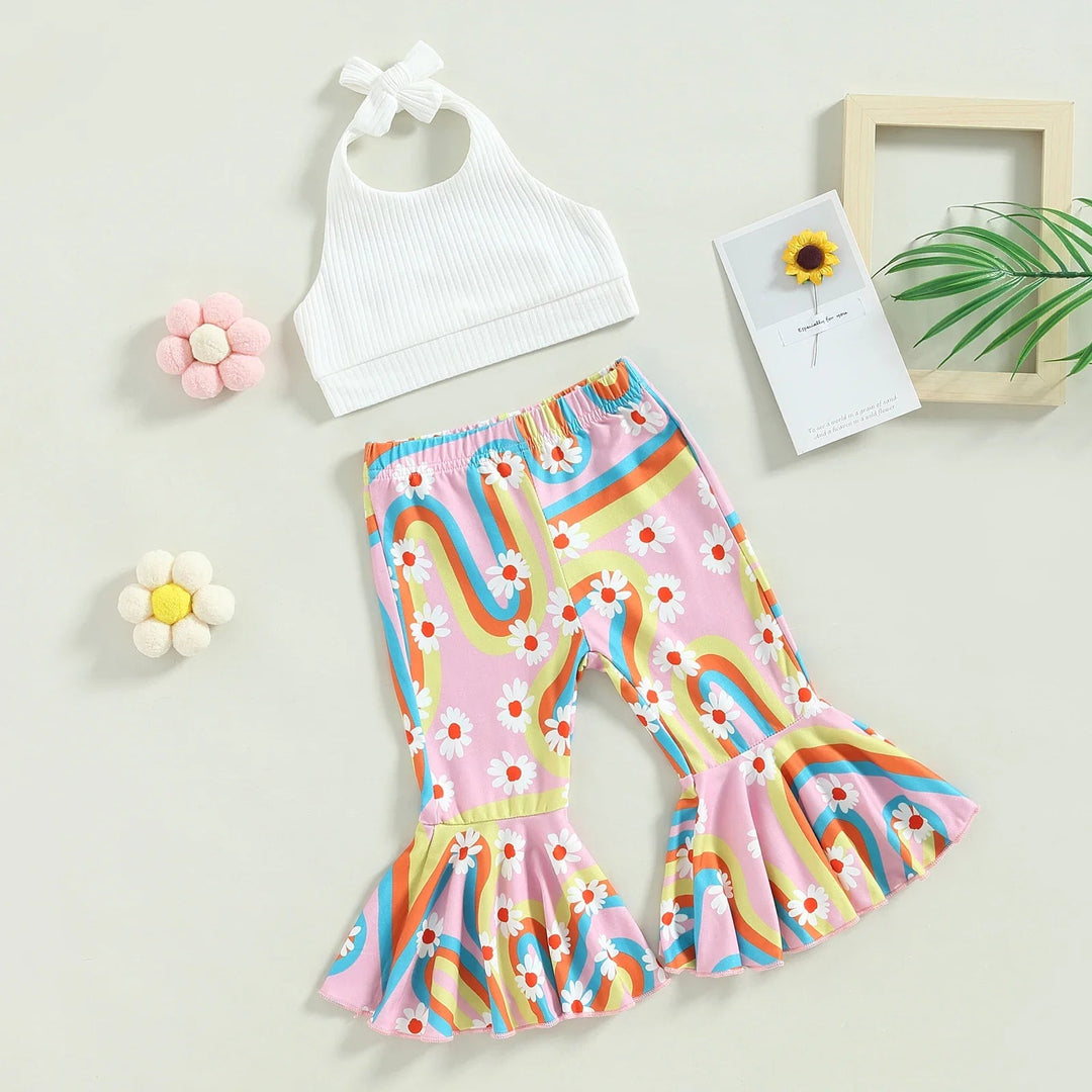 White ribbed halter top and pink rainbow-print pants with flared hems laid out together.