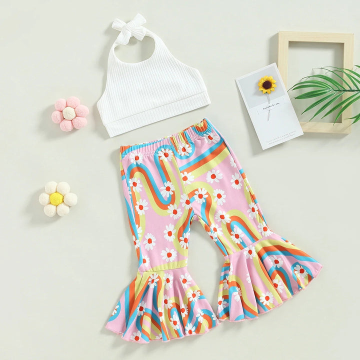 White ribbed halter top and pink rainbow-print pants with flared hems laid out together.
