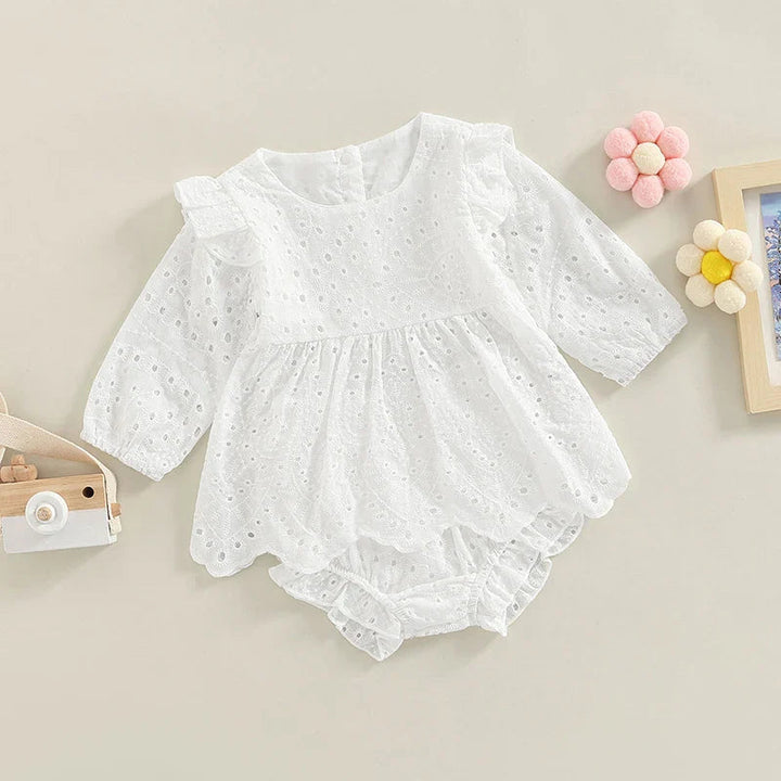 White baby outfit with a scalloped eyelet top layered over matching shorts.