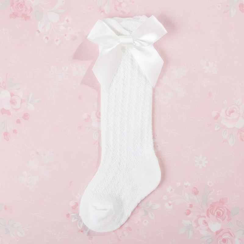 White pointelle knee-high sock with a matching satin bow