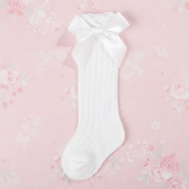 White pointelle knee-high sock with a matching satin bow