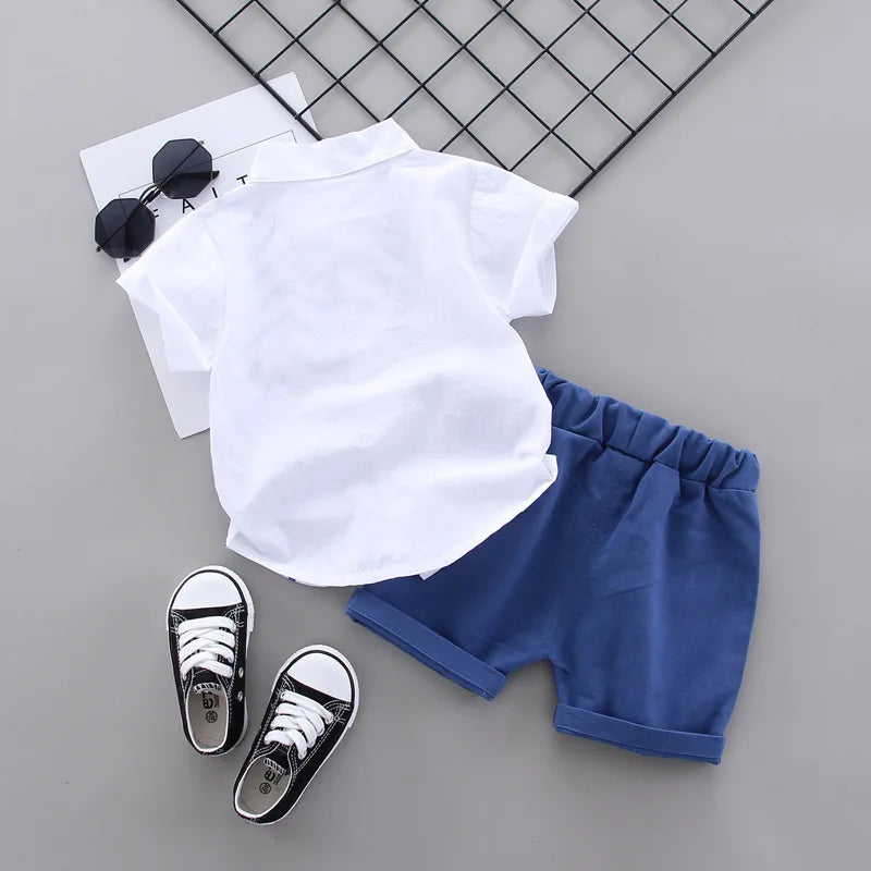 Back view of a white short-sleeve shirt paired with blue elastic-waist shorts