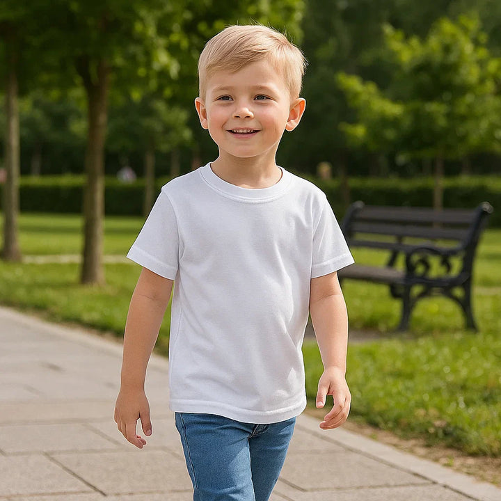 Child in a white short-sleeve T-shirt and denim shorts on a park path