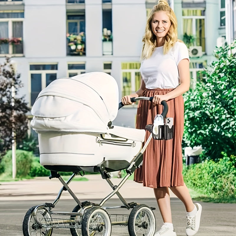 Woman standing beside a white stroller with a cup and phone holder attached.